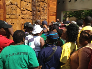 . .. highlights of the new constitution carved in a huge wooden door ...