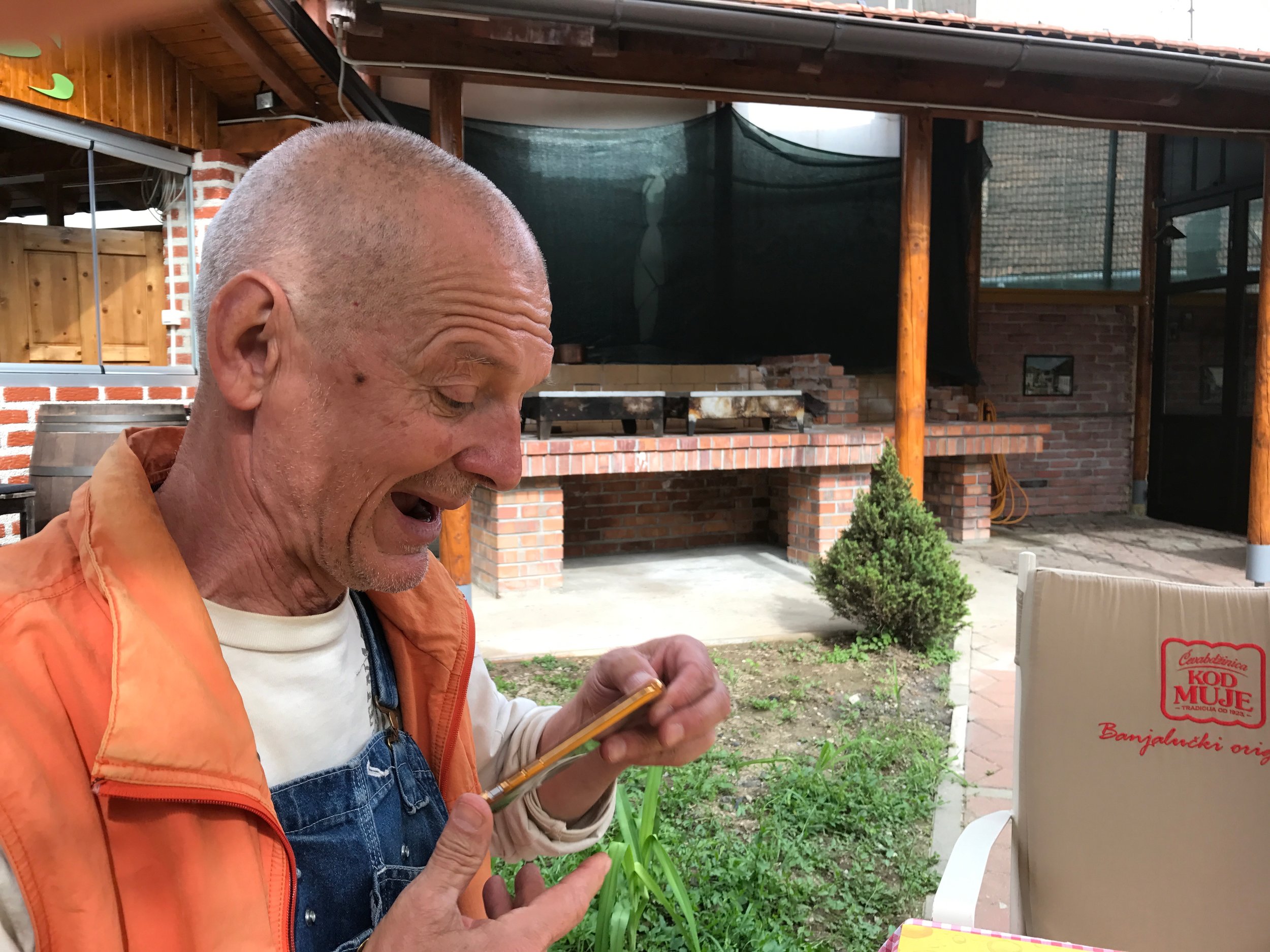 Djordje happily looking at his iphone (a gift of course) after we've walked around Banja Luka for an hour looking for a cup of real Turkish coffee).