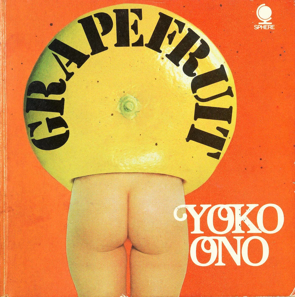 The cover of a book titled 'GRAPEFRUIT' with an image of a woman's naked buttocks, with her head and upper body replaced by a yellow grapefruit. The background is orange.