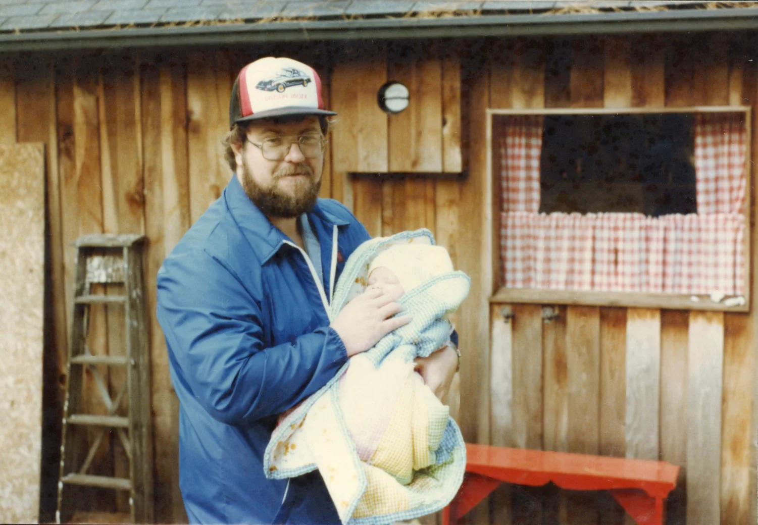 My dad holding me at our cottage when I was one month old.