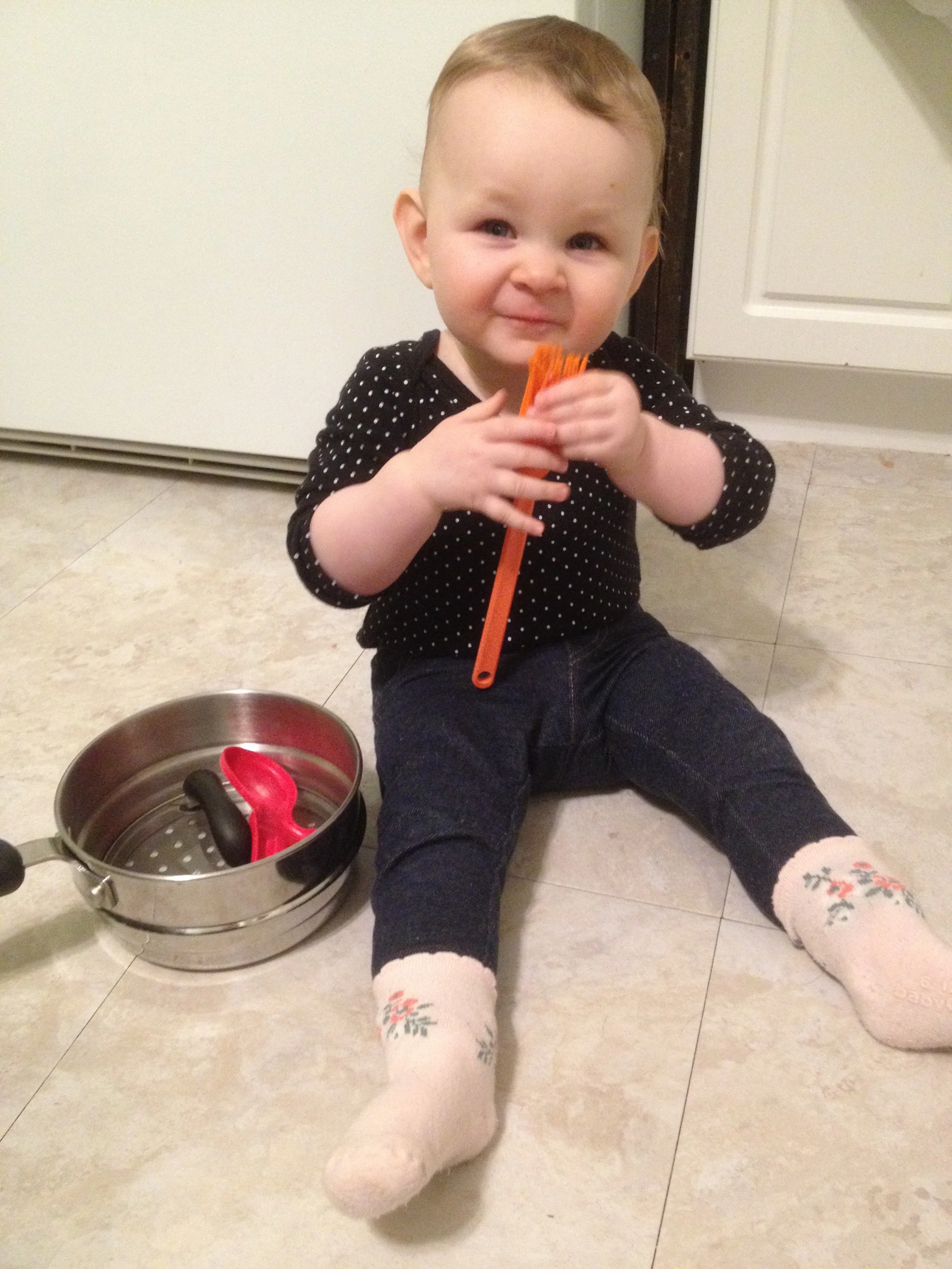 Playing with pots and random kitchen items while I do some dishes. Soon after this she learned to crawl and was barred from our kitchen so she wouldn't fall down the stairs. In the new house the basement stairs have a door - so excited for that! 
