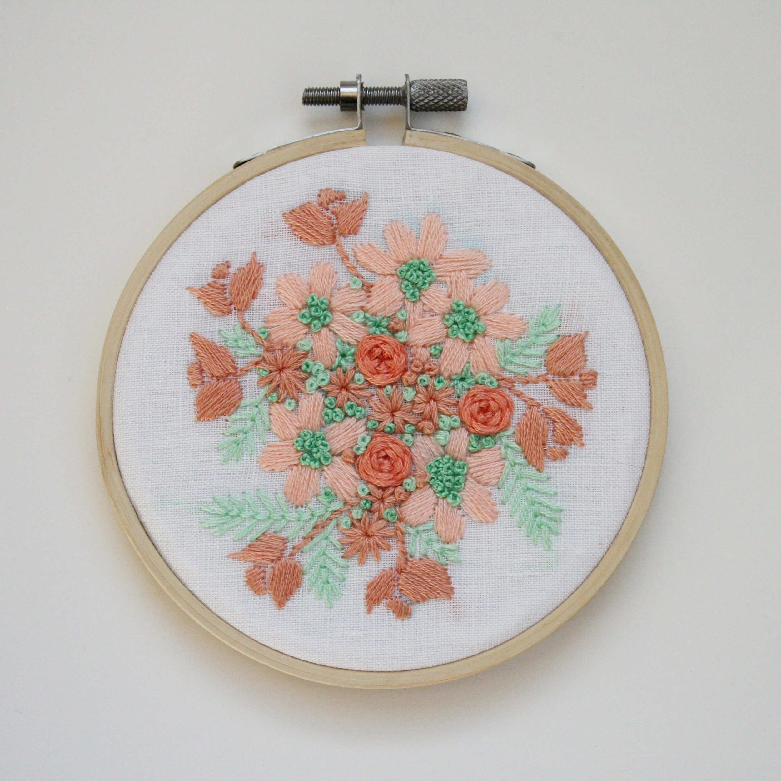 Peach and mint floral embroidery on white cotton