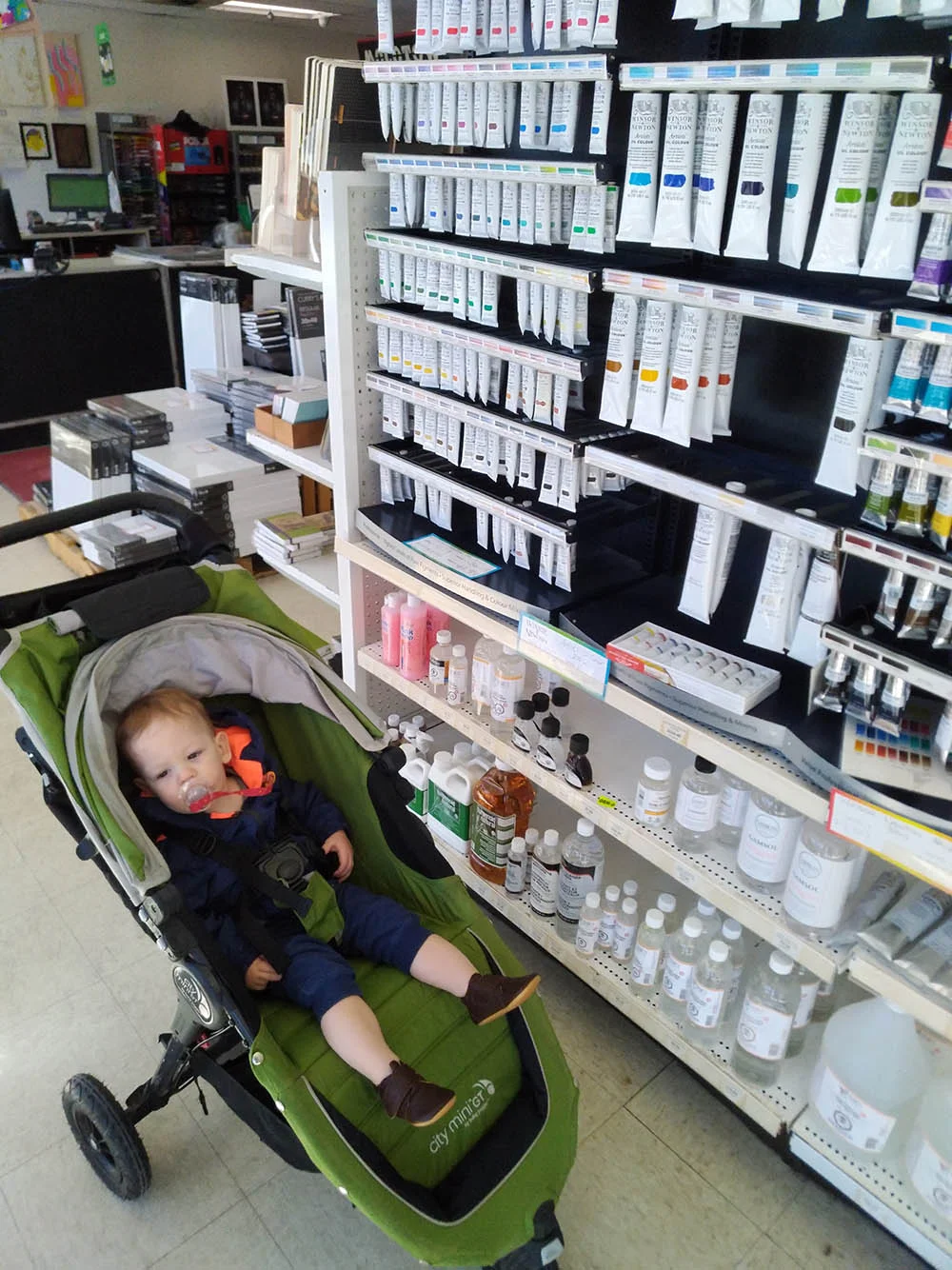 Why sit and be tired when you could be shopping for art supplies? OR if you are a baby you can do both at the same time!