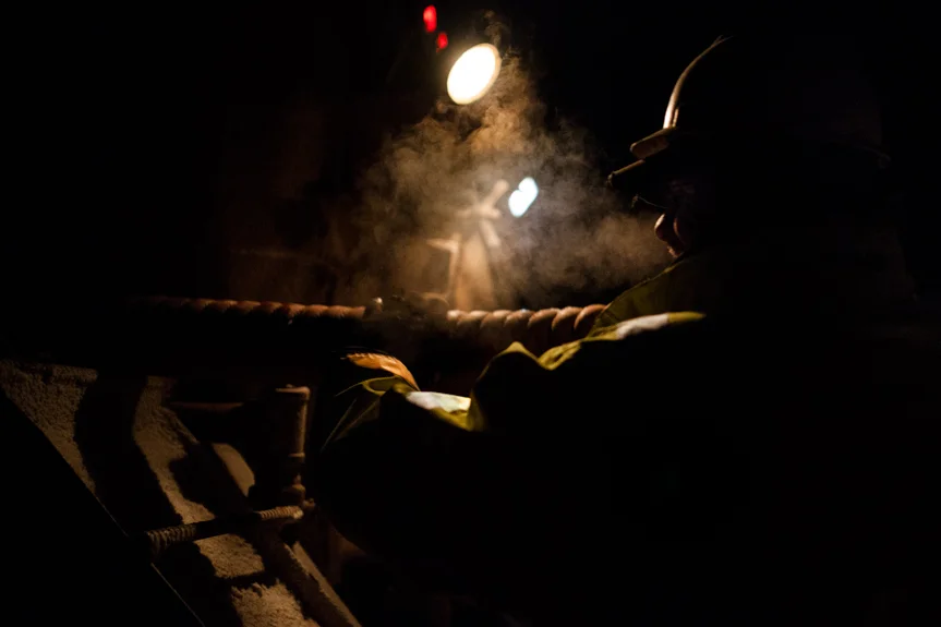 Trucker Derek Cross loads a hose onto his water truck at 3 AM after offloading water for a frack site.
