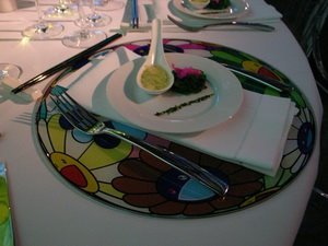 Takashi Murakami Placemats for LA MOCA and Brooklyn Museum (2007 and 2008) As Abramovic's gala suggests, the art world cares less about the grub and more about the tablescapes. So affirms the Murakami-themed raves of 2007 and 2008 when the Louis Vuitton gift-shopped carnival of © MURAKAMI went coast to coast . These limited-edition, fiberglass Murakami plates caused a minor furor in LA when model Naomi Campbell tried to nab the swag from other diners' place settings under the reasoning that she needed a full set. (The designer Tom Ford told her to do it.) When the circus arrived in Brooklyn, guests were red-carpeted through a metal-shuttered mock Chinatown where fake counterfeit Louis Vuitton hawkers sold real Murakami bags and Sabrett hot dog carts were repurposed to vendor champagne. But inside, it was the same plastic-plate squabble. Like Naomi before her, Jamie Snow, the wife of Brooklyn's Borough President Marty Markowitz, wanted to capitalize on her swag, too, gathering up other guests' placemats for herself. When gala-goers complained, Snow remarked, "You guys really should have acted faster. This is Brooklyn."