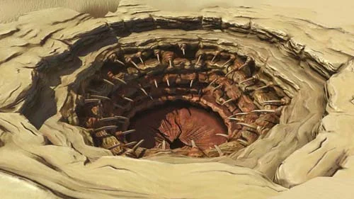 The Sarlacc pit, from Star Wars . Sure, it could be a sphincter, but either way, do NOT use the orifice, Luke. 