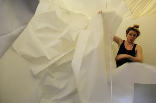 Joselyn applying the paper outer shell and inner paper walls and floor. 