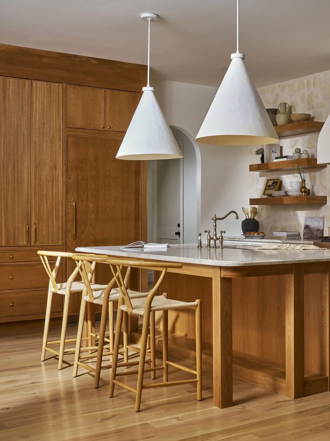 A kitchen designed in layers &mdash; where every material plays its part.

For Oakton, we paired off-white perimeter cabinetry with a warm wood island and reeded floor-to-ceiling cabinetry to create depth without overwhelming the space.

An overgrout