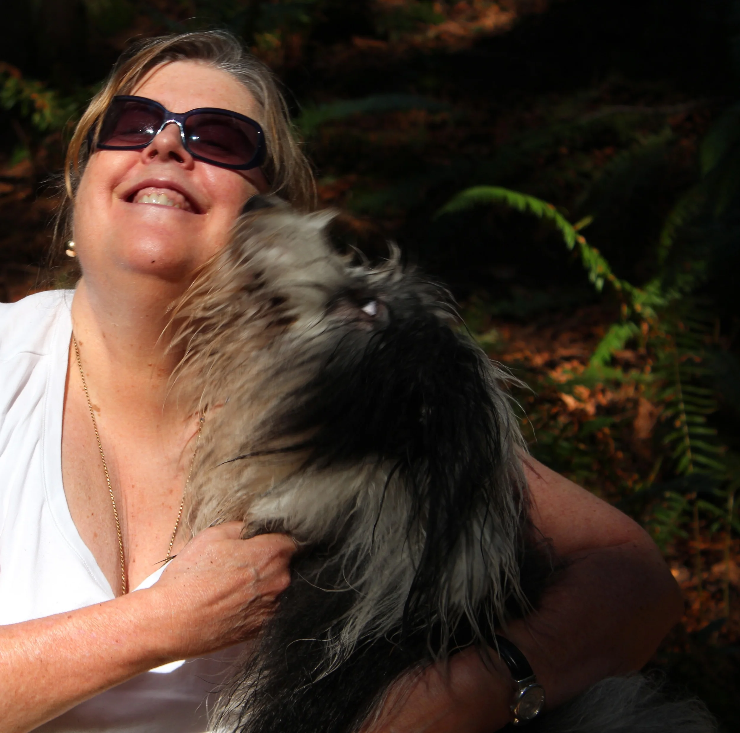 Lily is actually black and white, but not so after a day in the forest romping in water and mud! This is a picture of a happy woman and her dog, yes, but more, it's a picture of love. Of the generosity and joy of it.