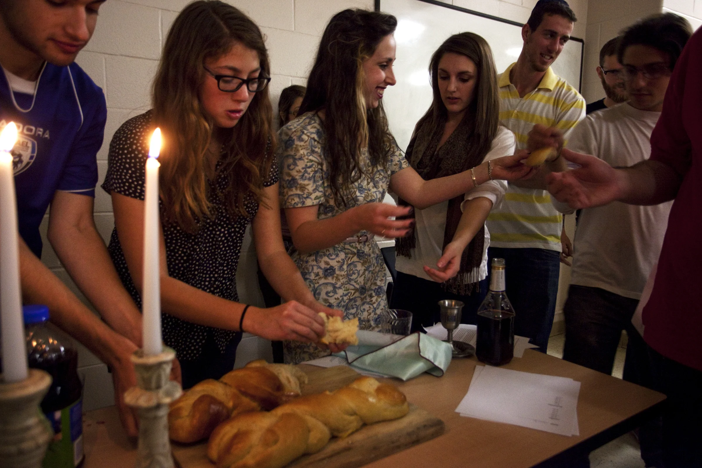 Tracy Jo Ingram, a Louisville, Ky senior, passes Challah, a traditional Jewish bread, around during the first Jewish Student Union Shabbat dinner on Friday, November 9,2012. Shabbat is the seventh day of the Jewish week, traditionally meant for rest. Western's Jewish Student is in its first year on campus.