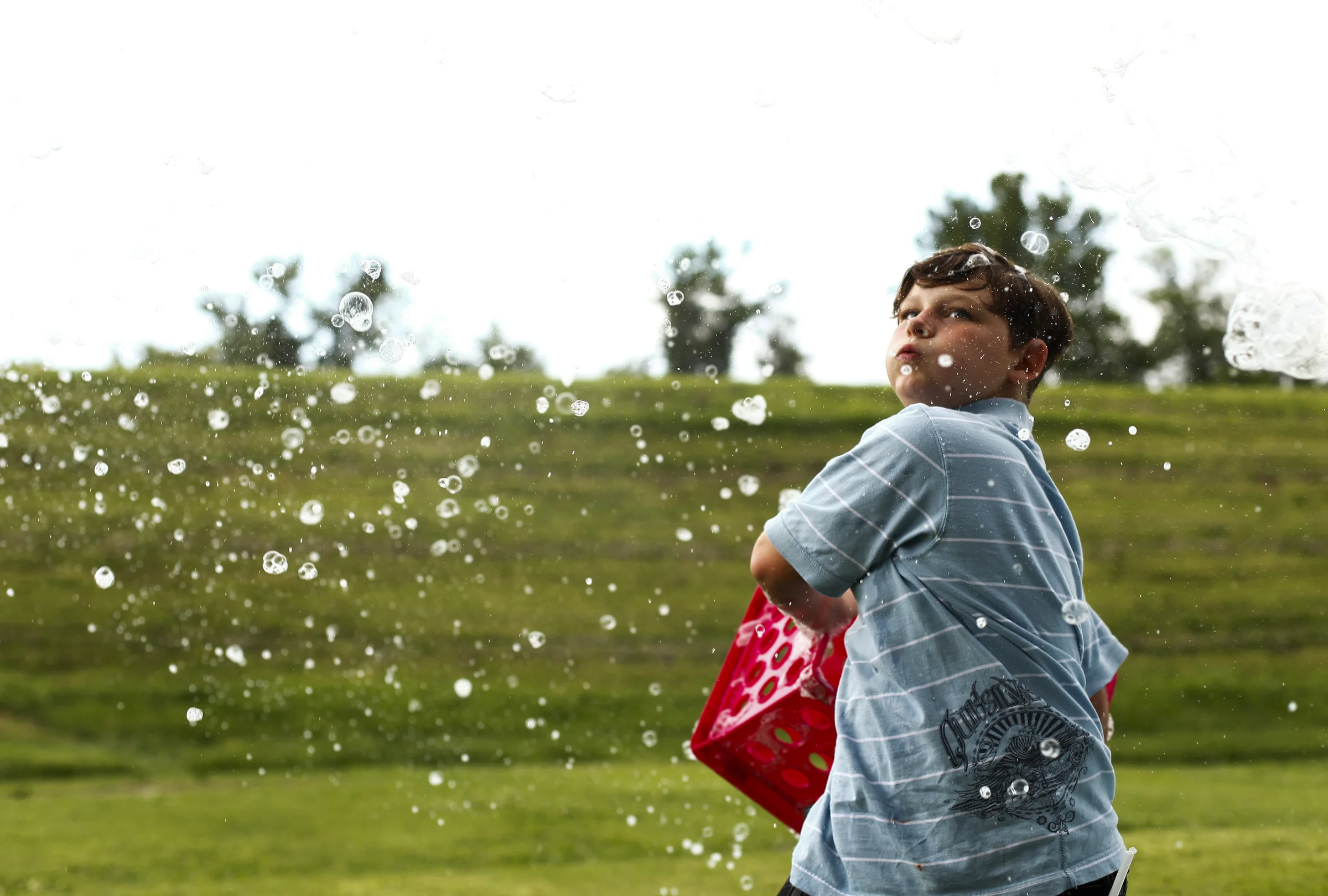 JT Powell, 10 of Uniontown, Ky., forms bubbles with a crate. 