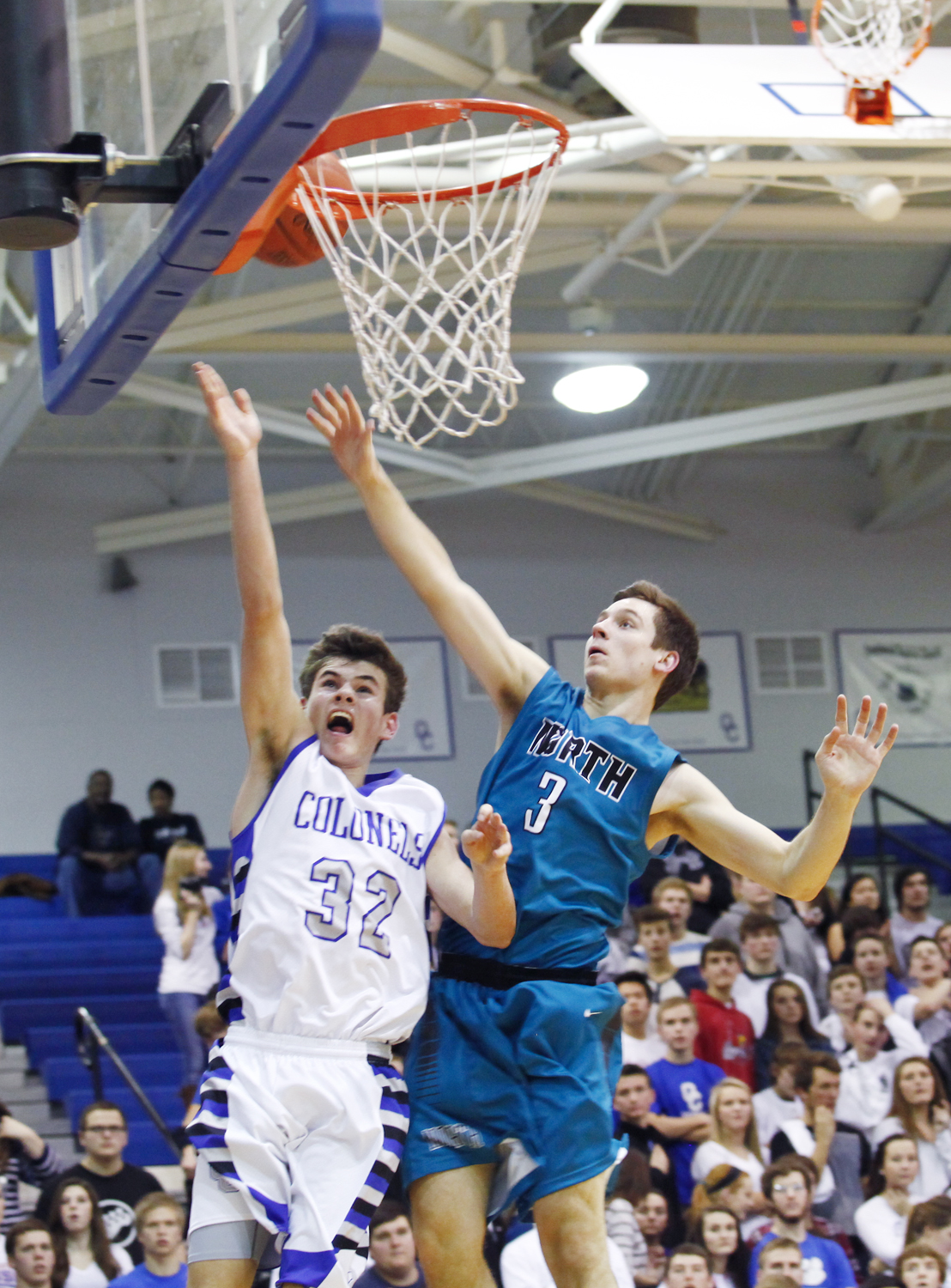Oldham County sophomore Griffin McLarty goes for a layup against North guard Trevor Burton during their January 30th 62-48 win in Buckner.