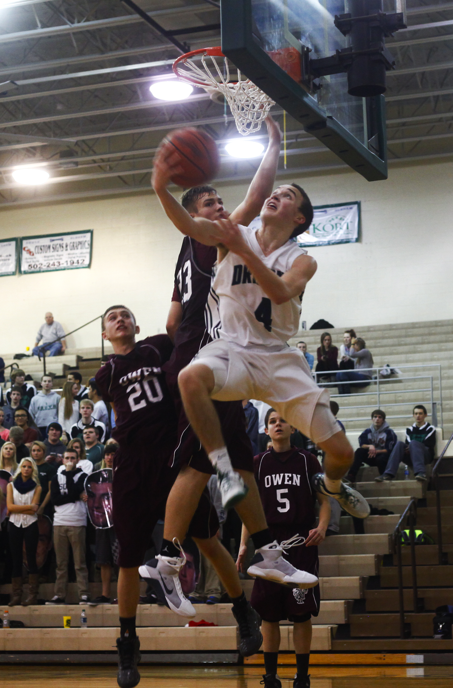 South Oldham guard Michael Griffin makes a reverse layup against Owen County sophomore guard Carson Williams during their 82 - 70 win against Owen on February 15 in Crestwood. 
