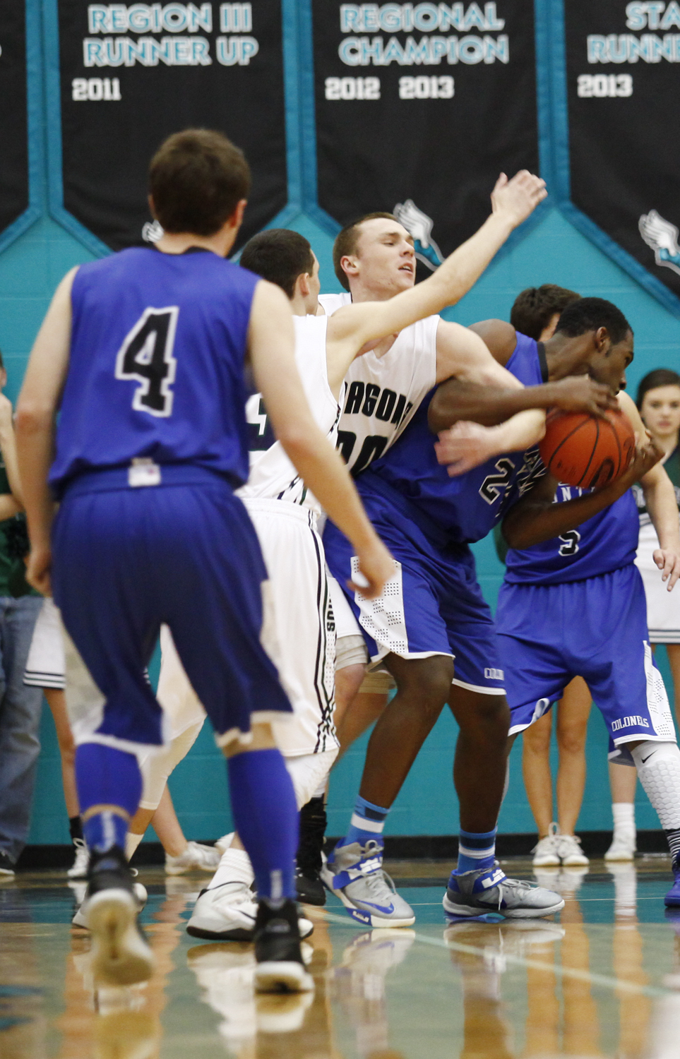 Oldham County senior Austin Perkins fights for possession during the Colonels 74-67 win over the Dragons in the final game of the District 29 Basketball Tournament in Goshen. 