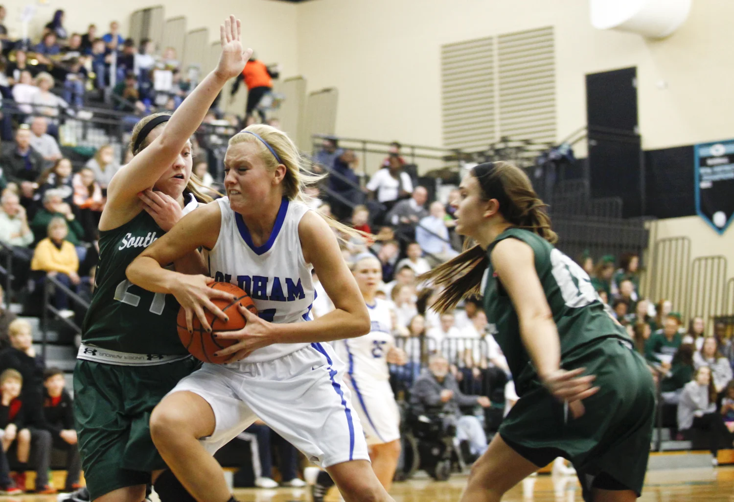 Oldham County guard Ashley McMurtrey fights to keep possession during the Lady Colonels 50-43 win over the Lady Dragons in the District 29 Girls Basketball Tournament in Goshen.