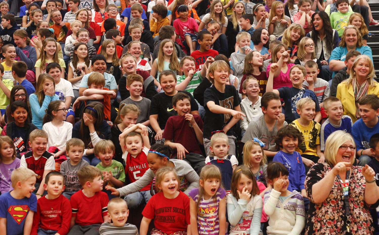 Locust Grove Elementary students react to their teachers kissing Herbert the pot belly pig during the schools annual Kiss the Pig fundraiser. 