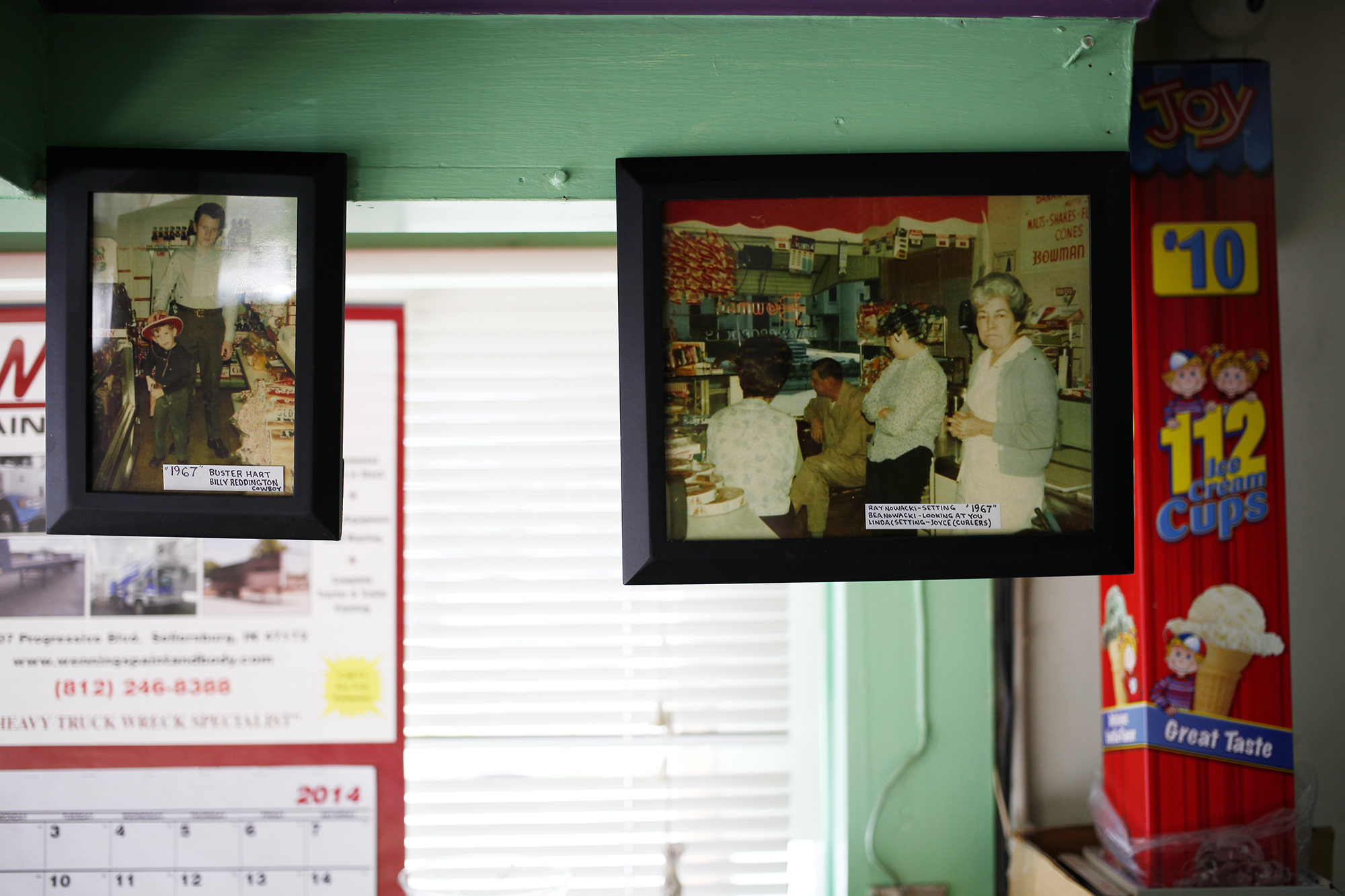 Images of former owners and customers hang in the In-and-Out Dairy Mart on Portland Avenue. 