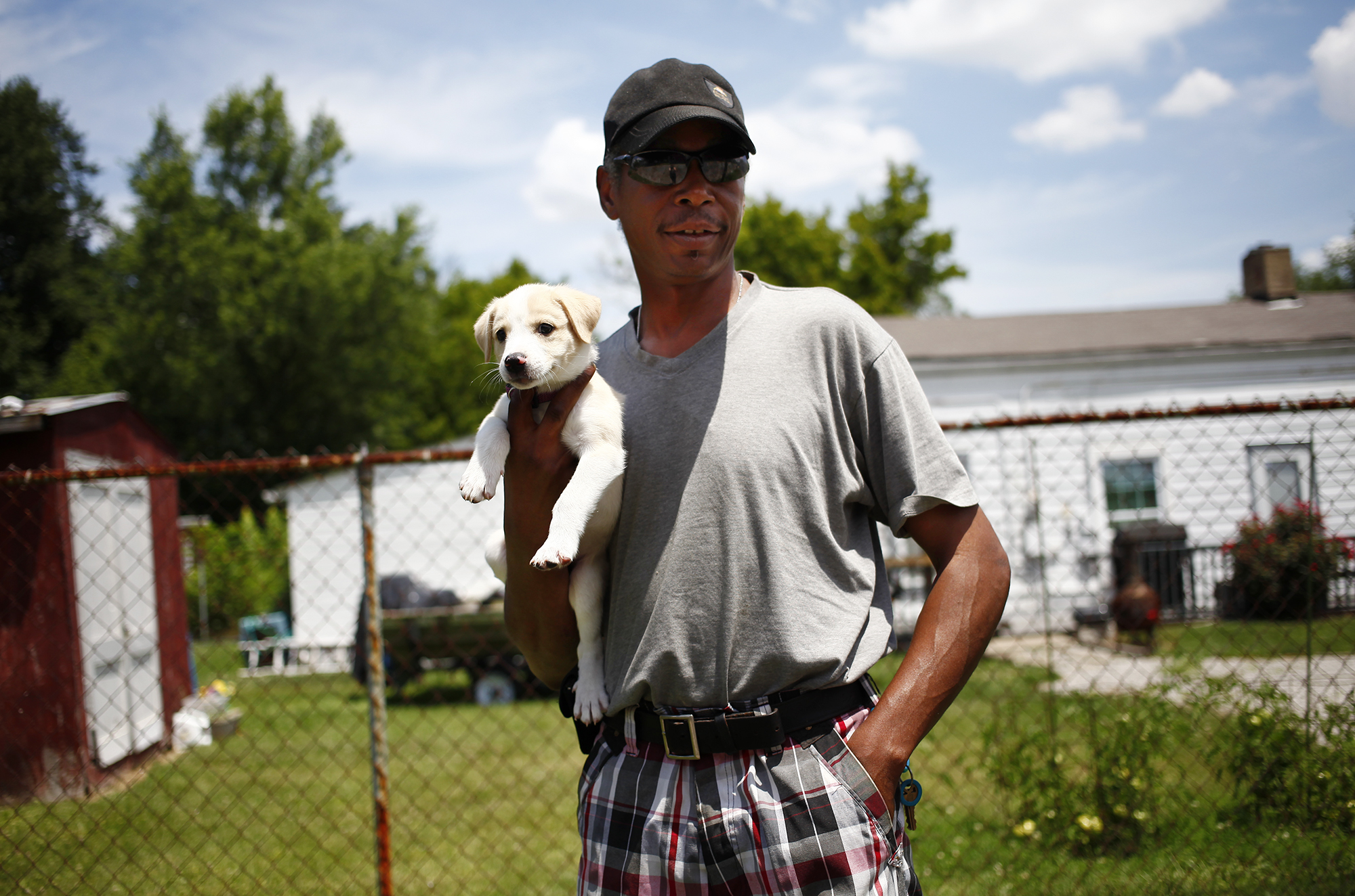 Tony Seabrooks stops for a portrait while en route to the vet with his puppy, Blondie, who was a Father's Day present for Seabrooks. 