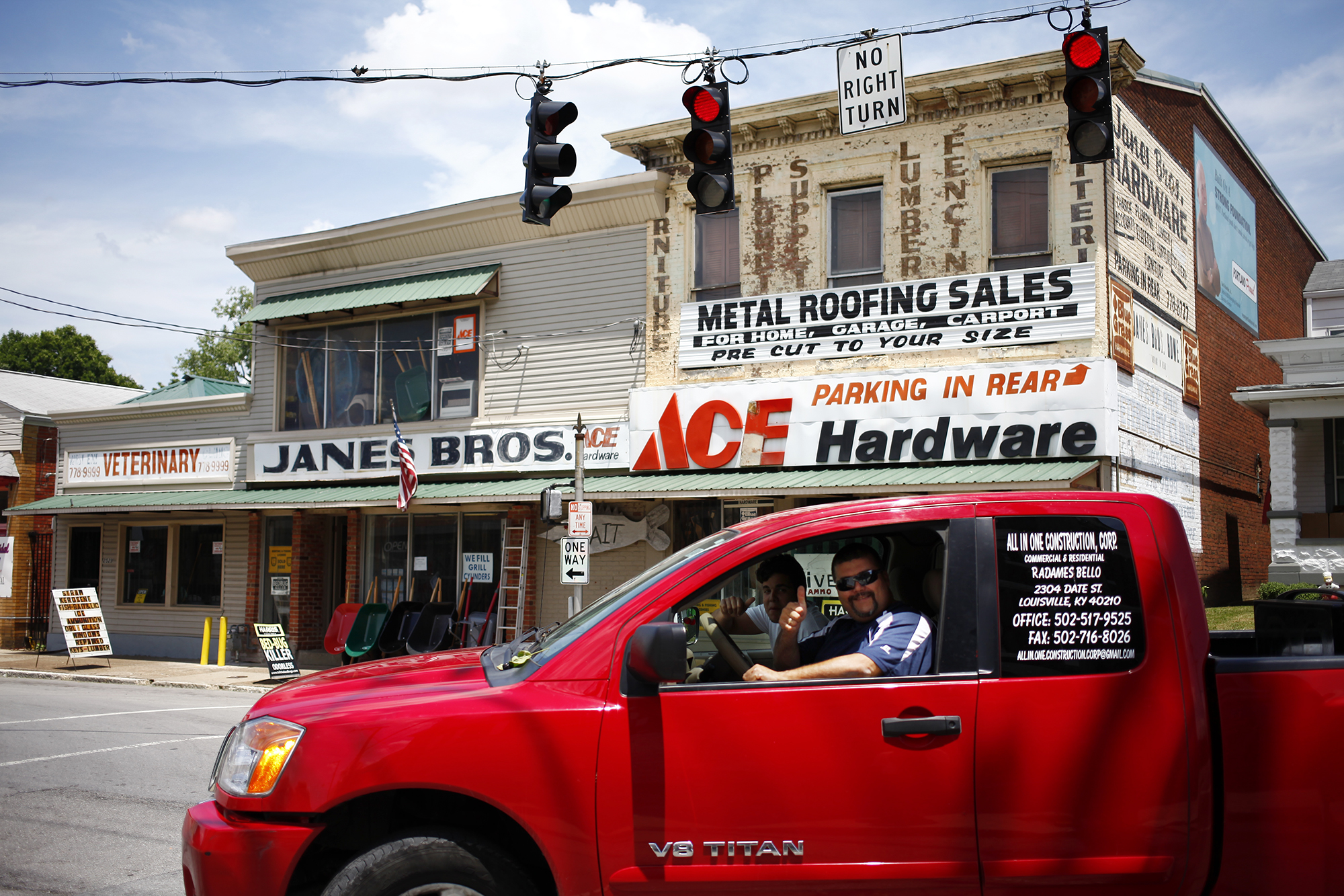 Passers-by ask to have their portrait made by Janes Brothers Hardware Store on Portland Avenue.