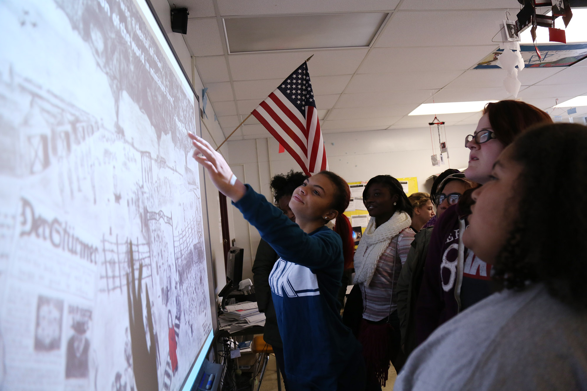 Students discuss Holocaust murals made by gifted students at a summer camp hosted by WKU.