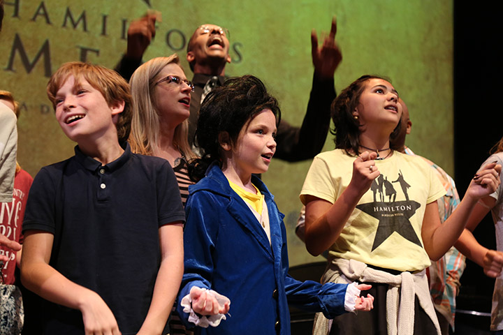  Youth sing along to songs from Hamilton. 