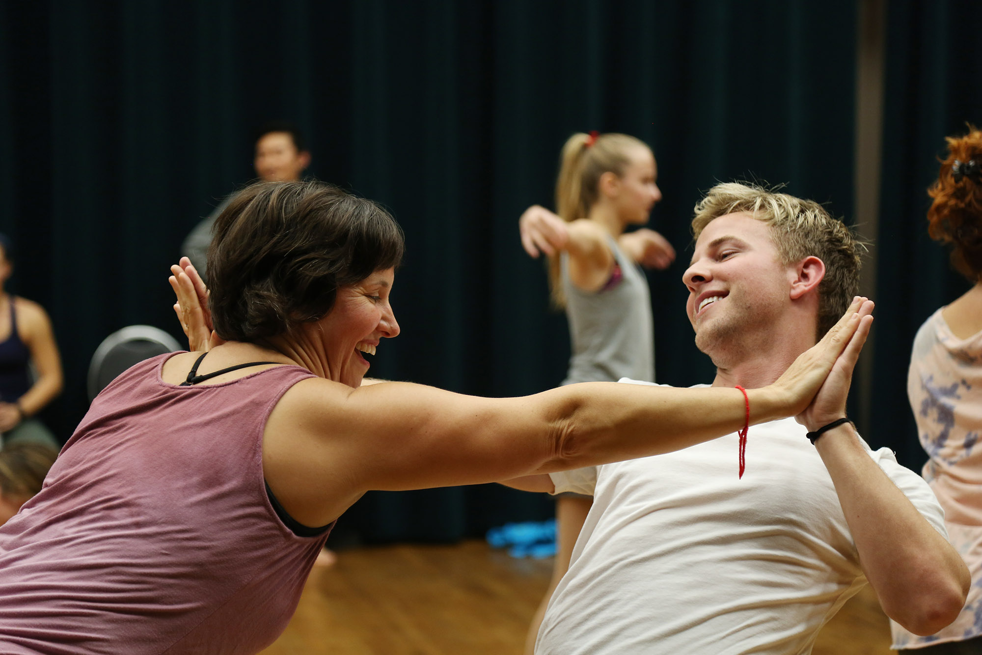 Community members dance together at a community movement workshop.