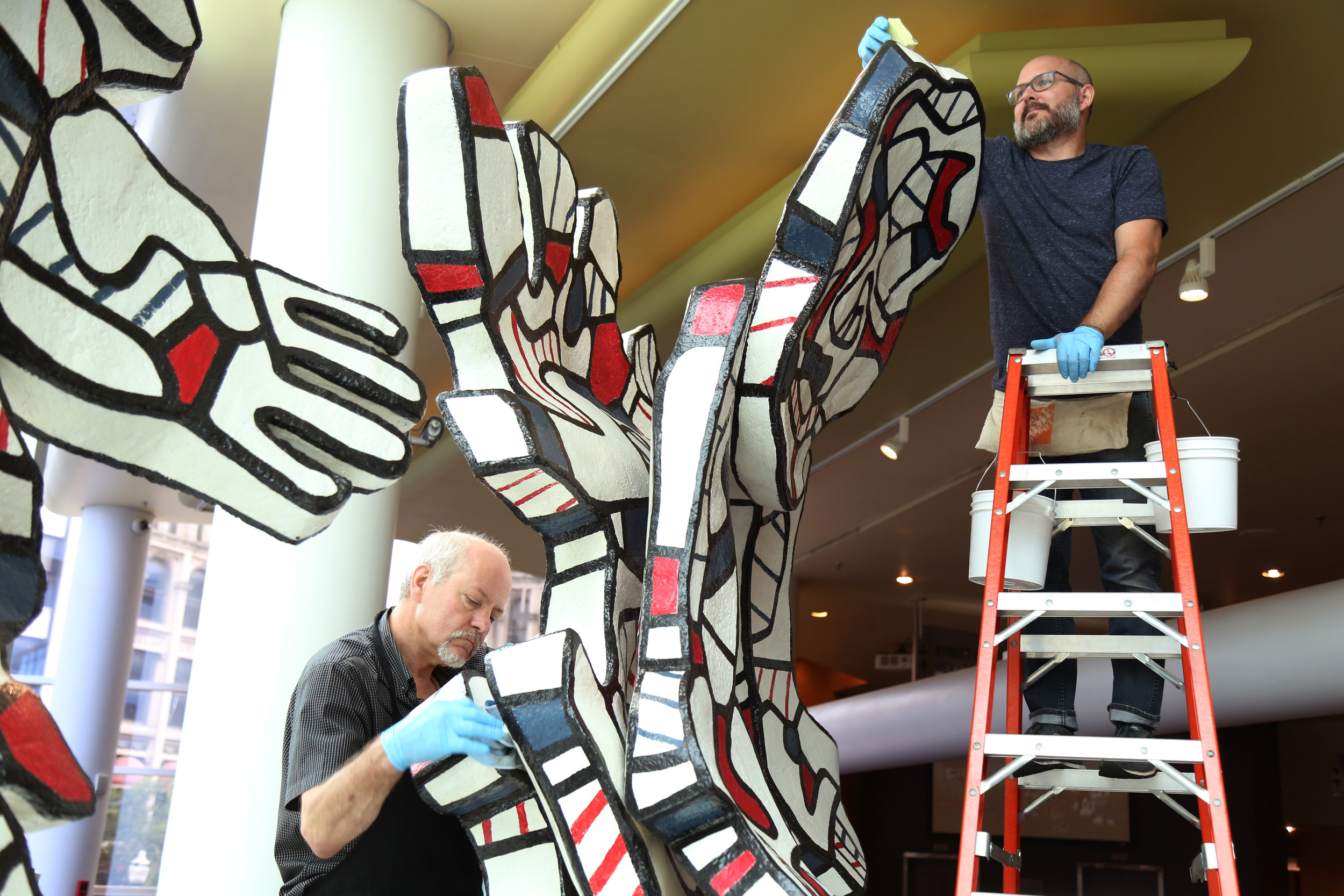     Conservators from The Conservation Center in Chicago clean “Faribolus and Perceval” by Jean DuBuffet. 