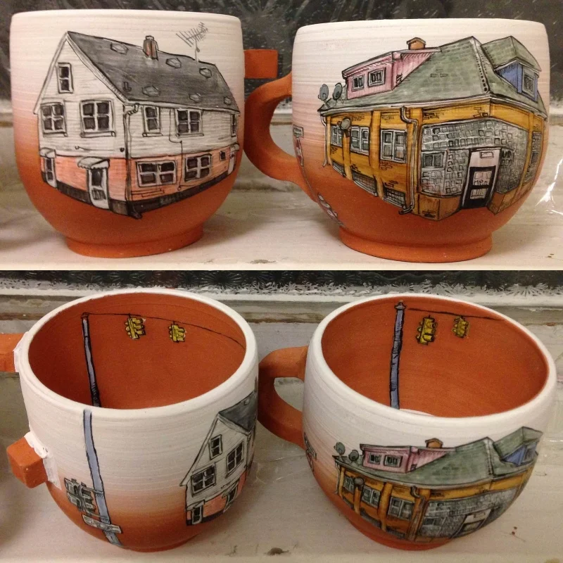Two bisqued Hamtramck House mugs ready to be glazed