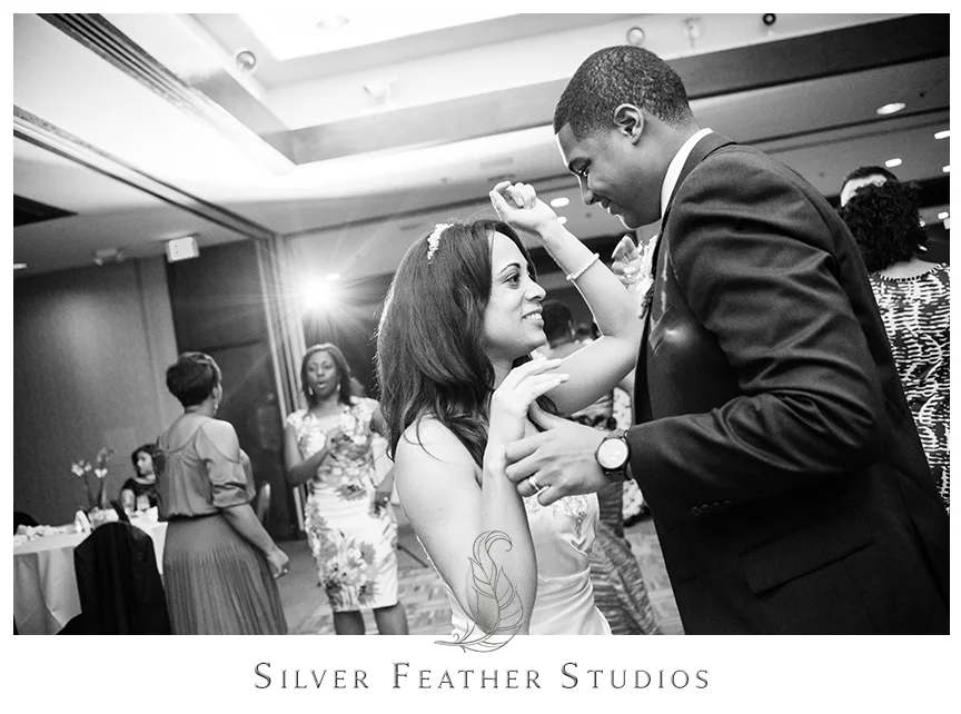Guests dance at this purple and gray Bryan Park Golf Center Wedding reception. © Silver Feather Studios, Wedding Photography in Greensboro, North Carolina.