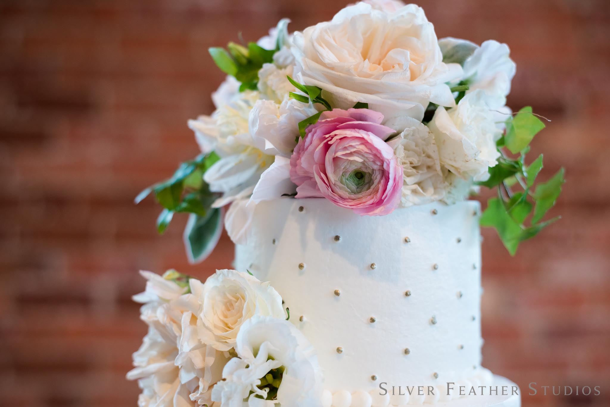 Ashley Cakes designs a gold and champagne-dotted four tier wedding cake for this cotton room wedding. © burlington wedding photographer, silver feather studios.