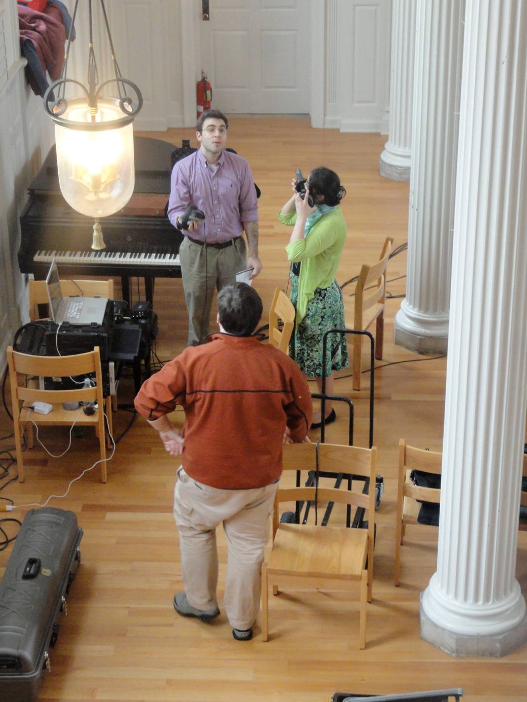 Derek and Grace discuss a take with engineer Mateusz Zechowski in Marquand Chapel, Yale Divinity School