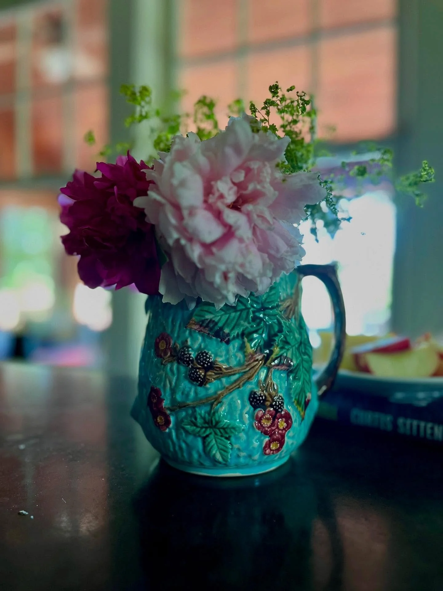 The last of the peonies, lavender, and lady&rsquo;s mantle in a pitcher that my mom gave me.  The blackberries and blooms carved into the clay harbingers of summer&rsquo;s gifts.

We&rsquo;ve been eating freshly picked strawberries with cream.  The t