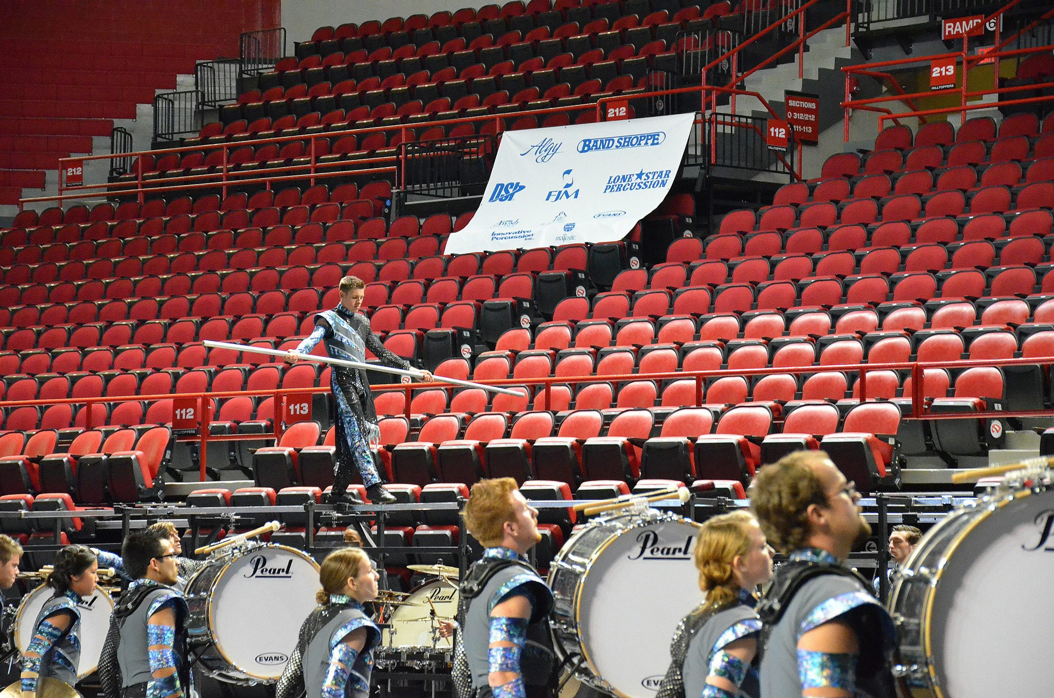 Center Snare Frankie Cummings walks the percussion rack balance beam at the WGI Mid-South Championships.