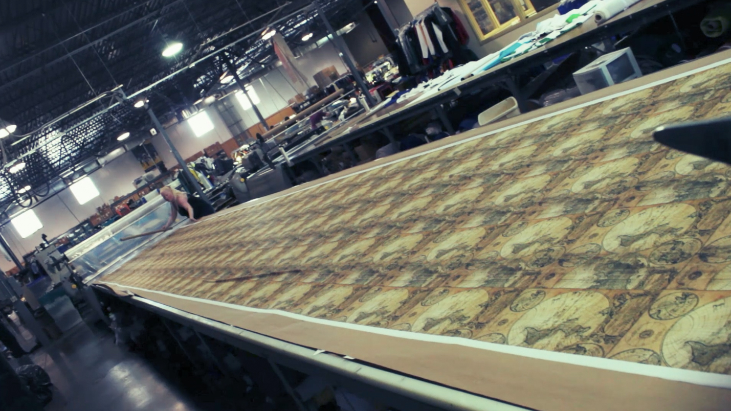  The digitally screen printed fabric is queued up on the table, to be pulled into the cutter. 
