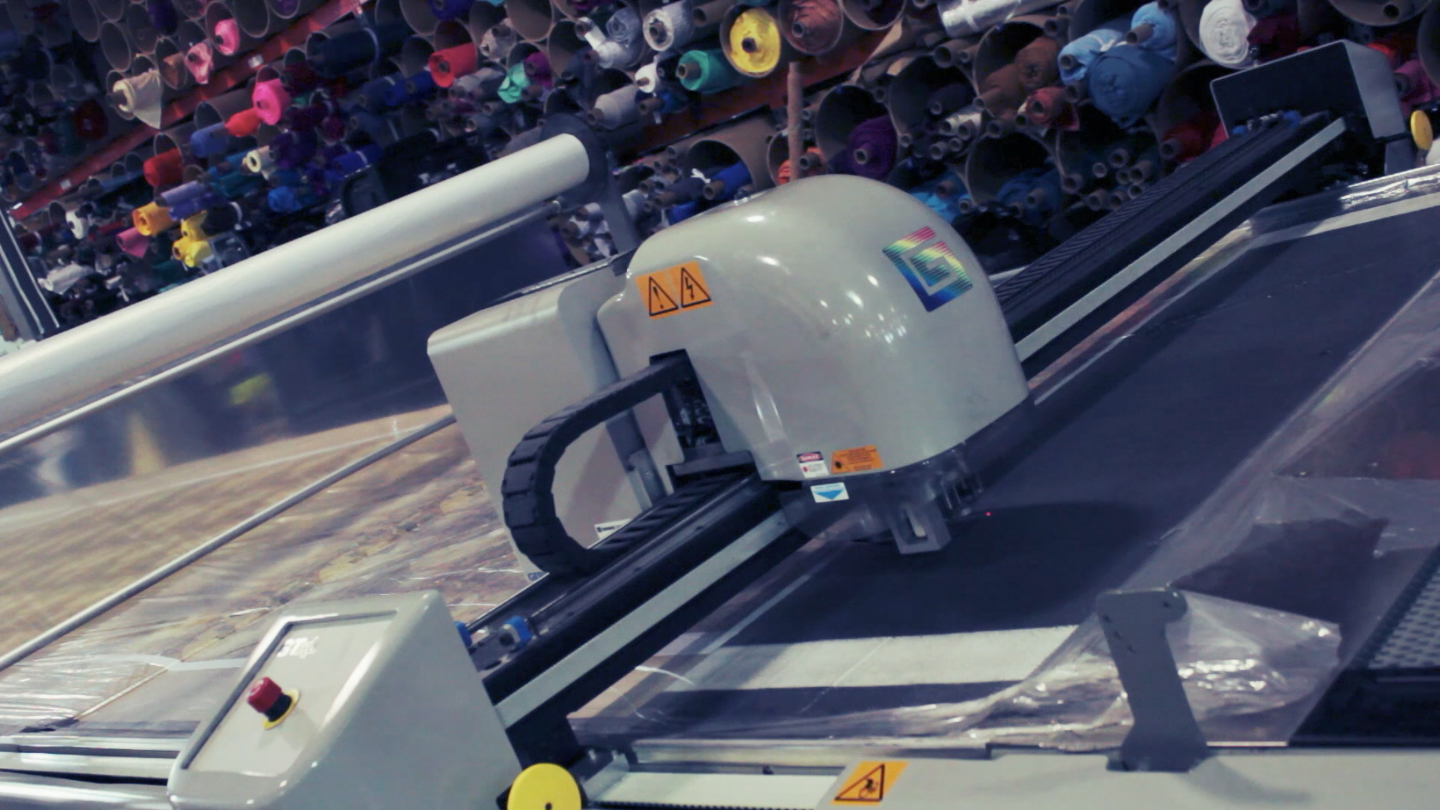  The cutter is digitally controlled and cuts thousands of pieces to be sent to sewing. 