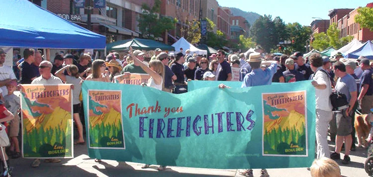 A firefighter parade marched through downtown Boulder with my art as the headlining banner.