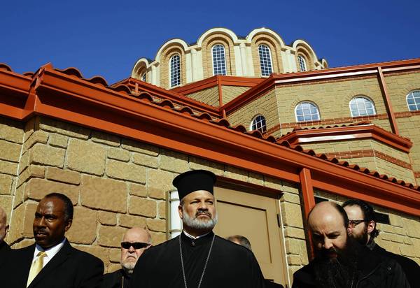Outside St. Demetrios Greek Orthodox Church in Waukegan at a news conference addressing vandalism of the church, which occurred the same night as a similar incident at a nearby mosque. From left are Imam Matthew Ramadan of the Council of Islamic Organizations of Greater Chicago, Rev. James Gordon of Ascension of Our Lord Greek Orthodox Church in Lincolnshire, Bishop Demetrios (center) of the Greek Orthodox Metropolis, Rev. Cosmas Halekakis, pastor at St. Demetrios and Rev. Sotirios Malamis (partially hidden), of St. John the Baptist Greek Orthodox Church in Des Plaines. (Chris Walker, Chicago Tribune / February 19, 2014)
