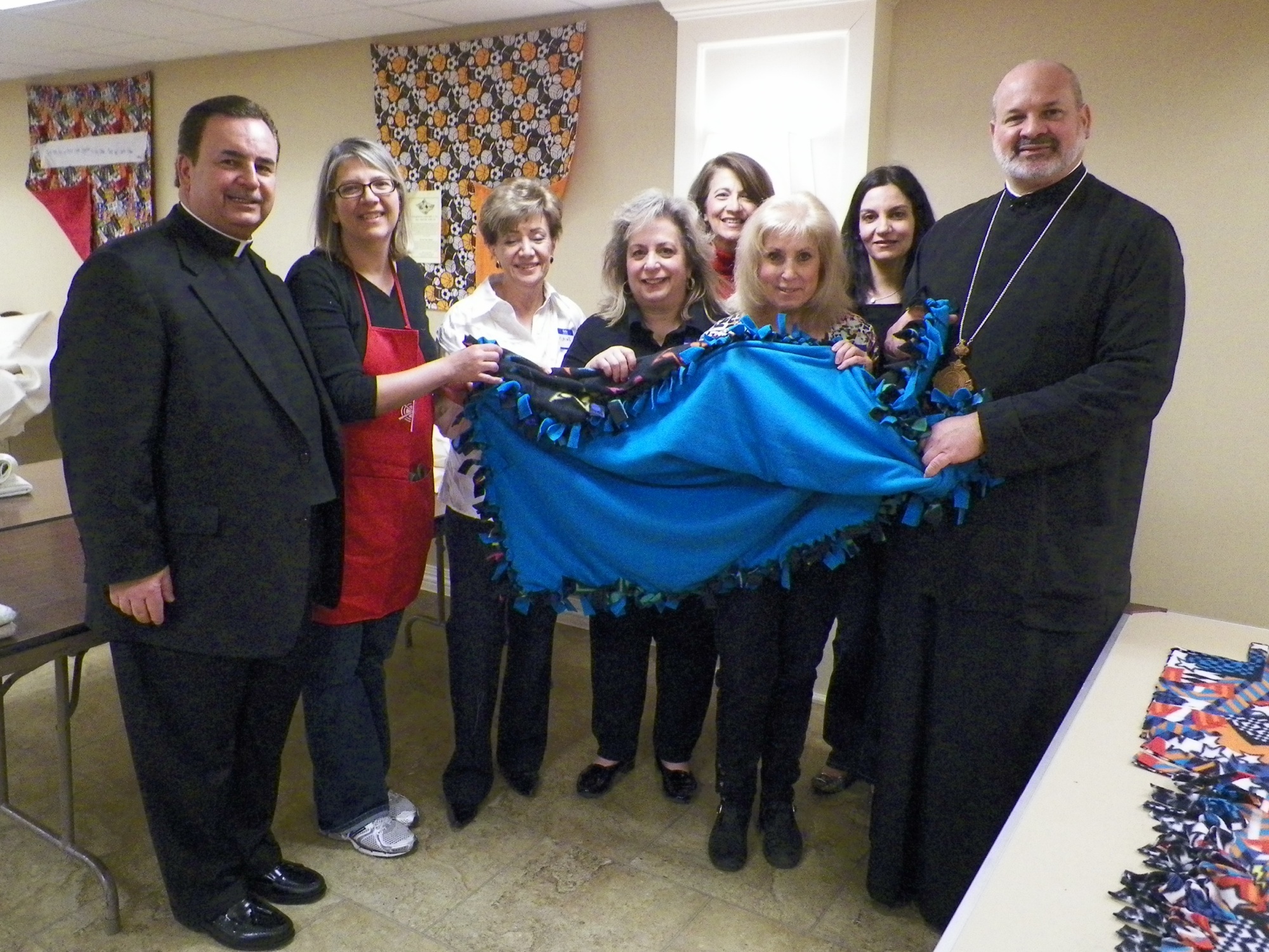 Pictured (from left) at the Lenten Quilt-a-thon recently hosted by the Philoptochos Society of Saints Peter and Paul Greek Orthodox Church in Glenview: Fr. James Dokos, protopresbyter of the church; event co-chair Karen Venson; several Quilt-a-thon participants and His Grace Bishop Demetrios of Mokissos, Chancellor of the Chicago Metropolis.
