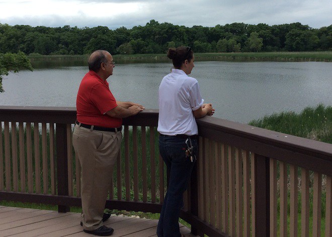 Bill J. Vranas, the president of the St. Iakovos Retreat Center Board, and Chrysanthy Tiggas, the director for the center, look out over the lake adjourning the center in Kansasville.