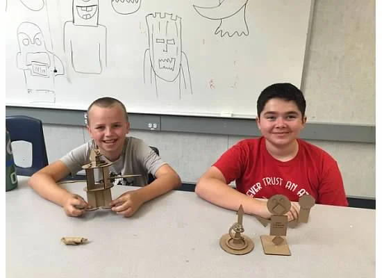 Cardboard construction with shapes.