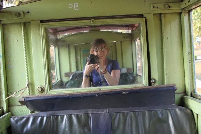 A self-portrait, taken inside a mirrored horse-drawn cart in Myanmar. I couldn't stop smiling and I was completely alone.