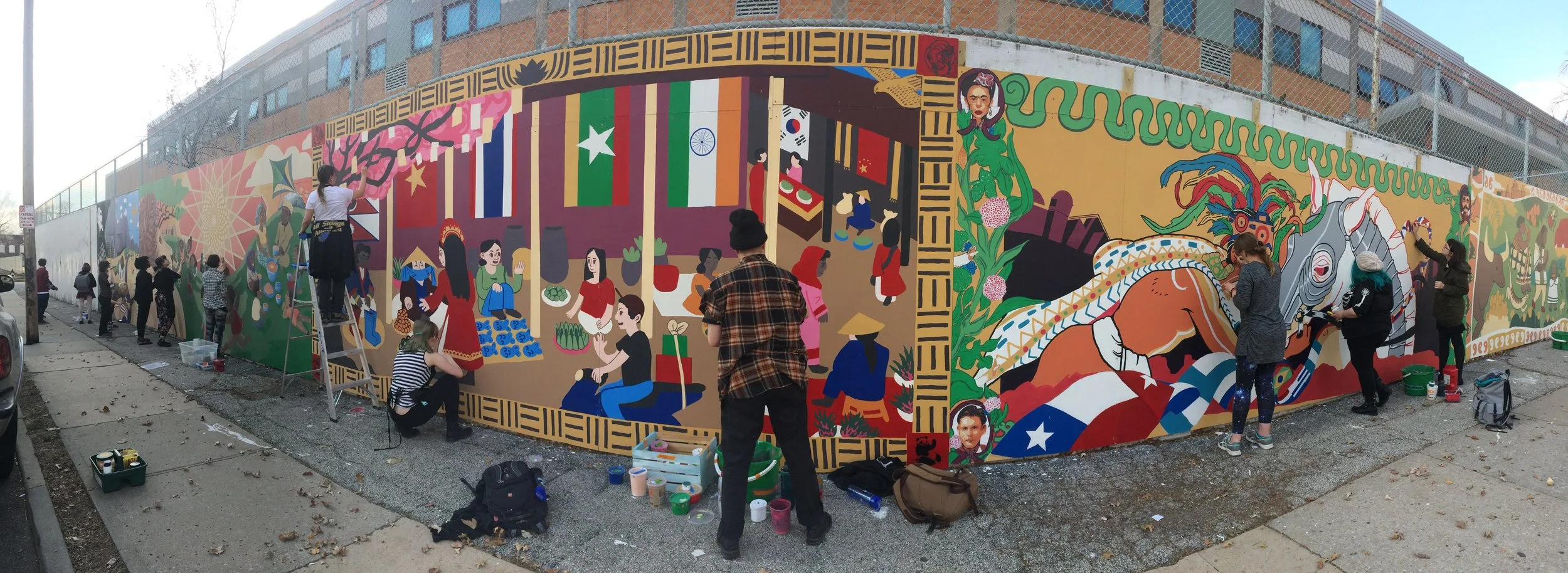 KCAI juniors touching up the mural after installation