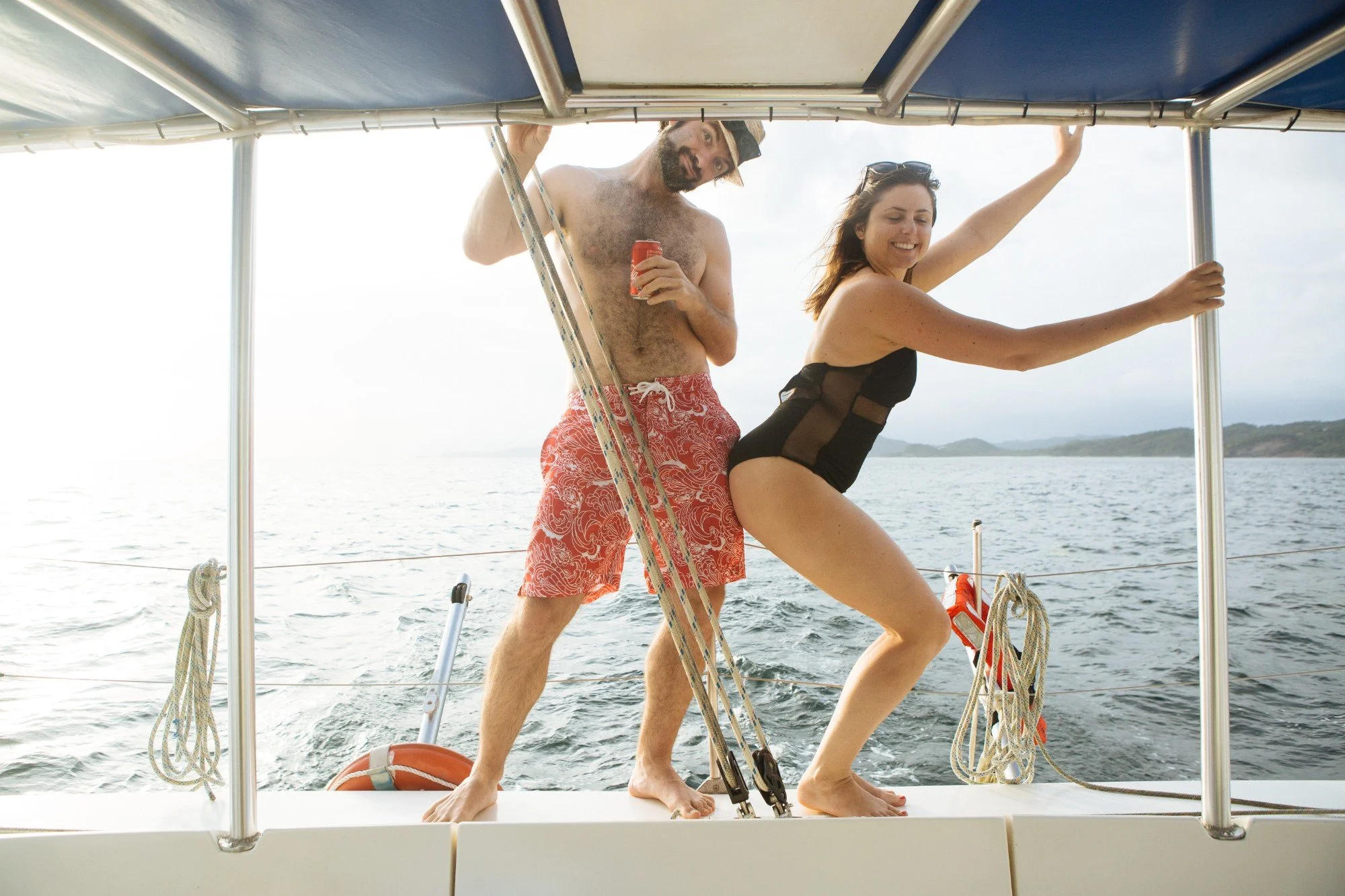 Travelers dancing on a catamaran deck at sunset, group travel photography in Nicaragua
