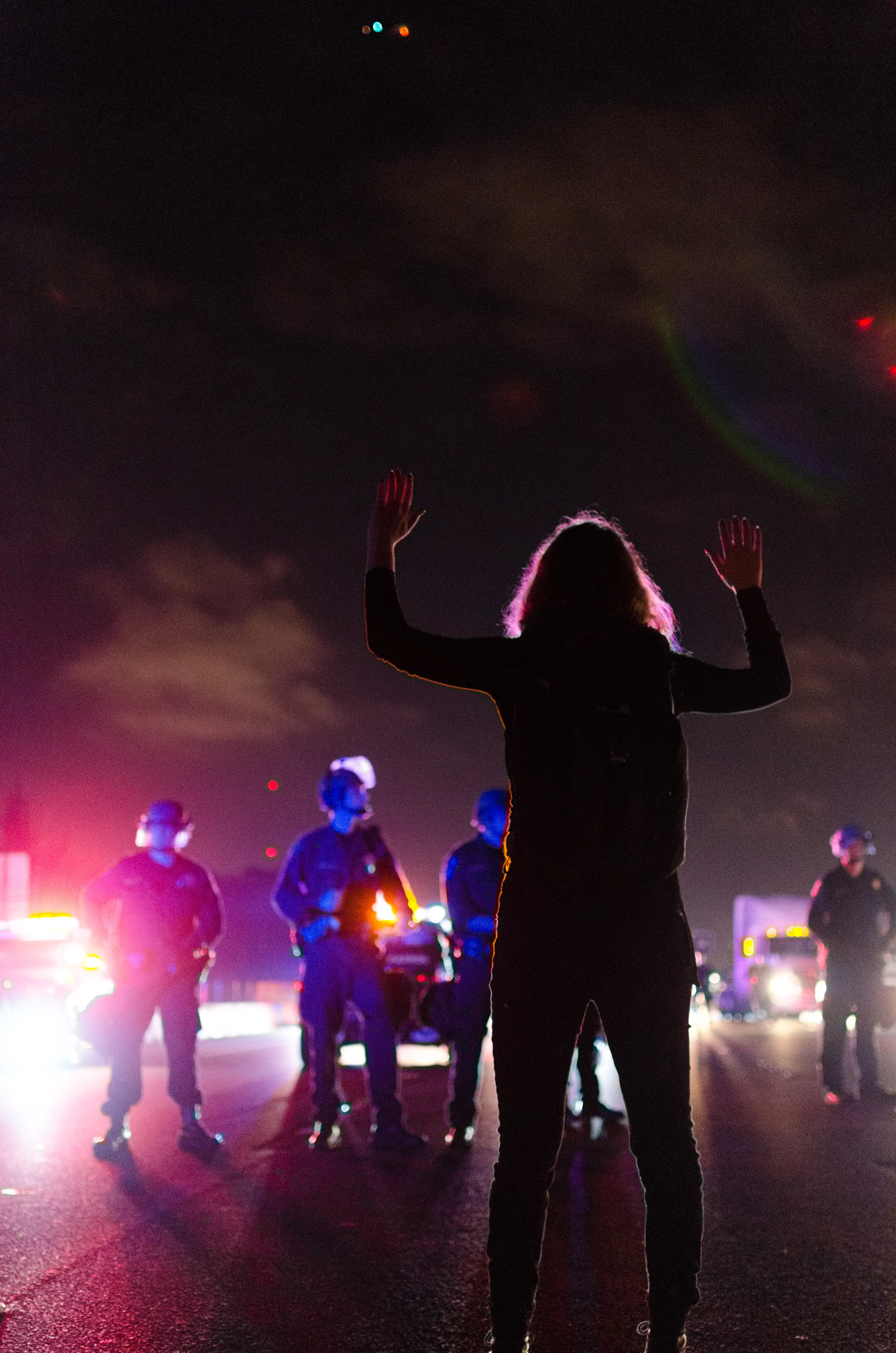 Woman facing police on the Northbound lane of Interstate 80 in Berkeley, CA on December 8th, 2014 - photo by Kyle Cameron