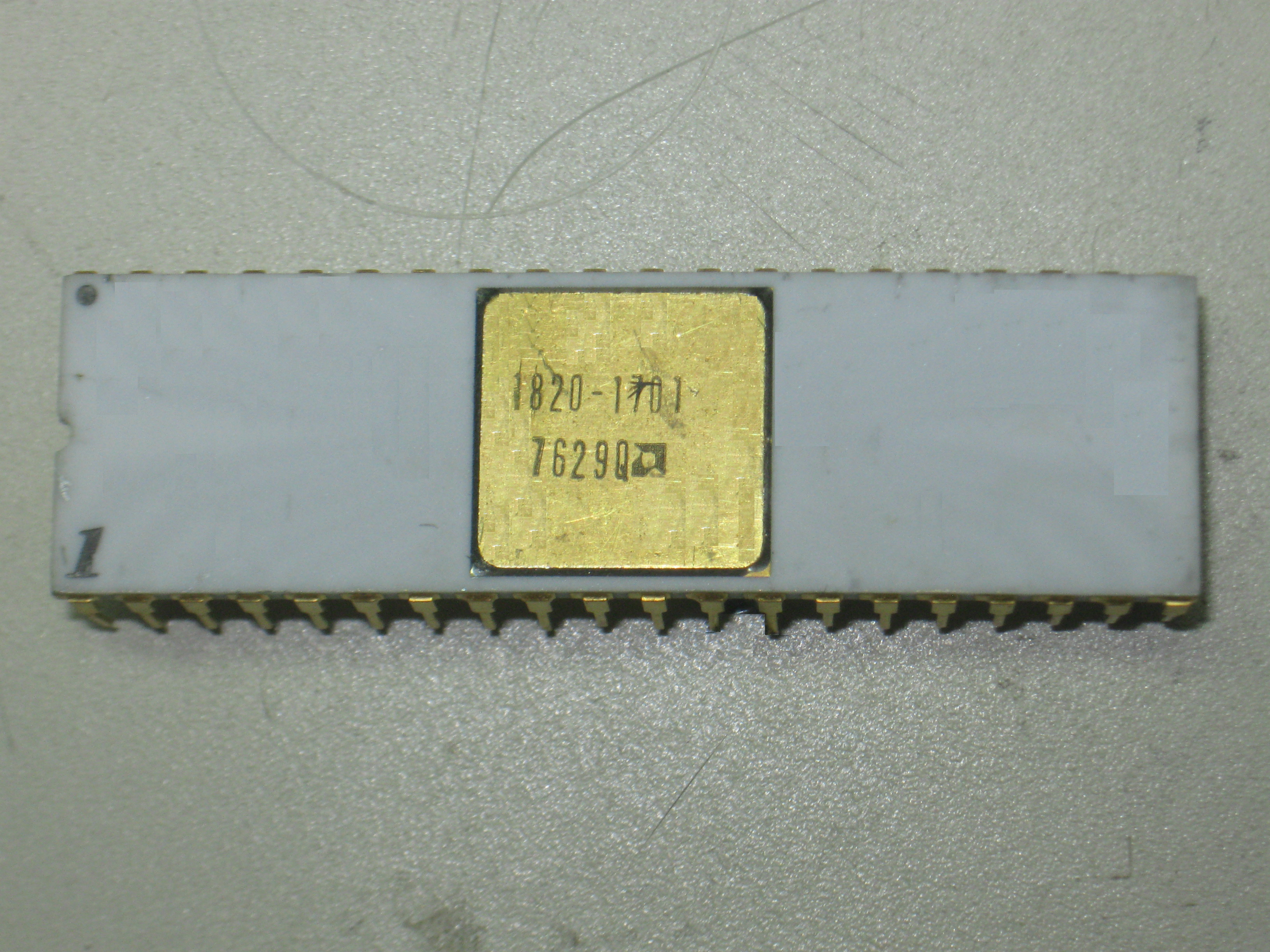 An Intel 8080 microprocessor made by AMD in the 29th week of 1976 for Hewlett-Packard under HP's part number 1820-1701. White ceramic with side welded gold plated pins and gold cover. Pin 1 is pretty obvious, but there is also a dot on pin 40 - odd.