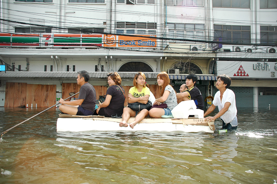  Residents in a flooded Bangkok neighborhood use a makeshift floatation device. 
