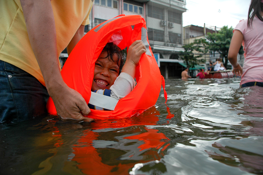  A toddler enjoys the water in a newly flooded Bangkok neighborhood. 