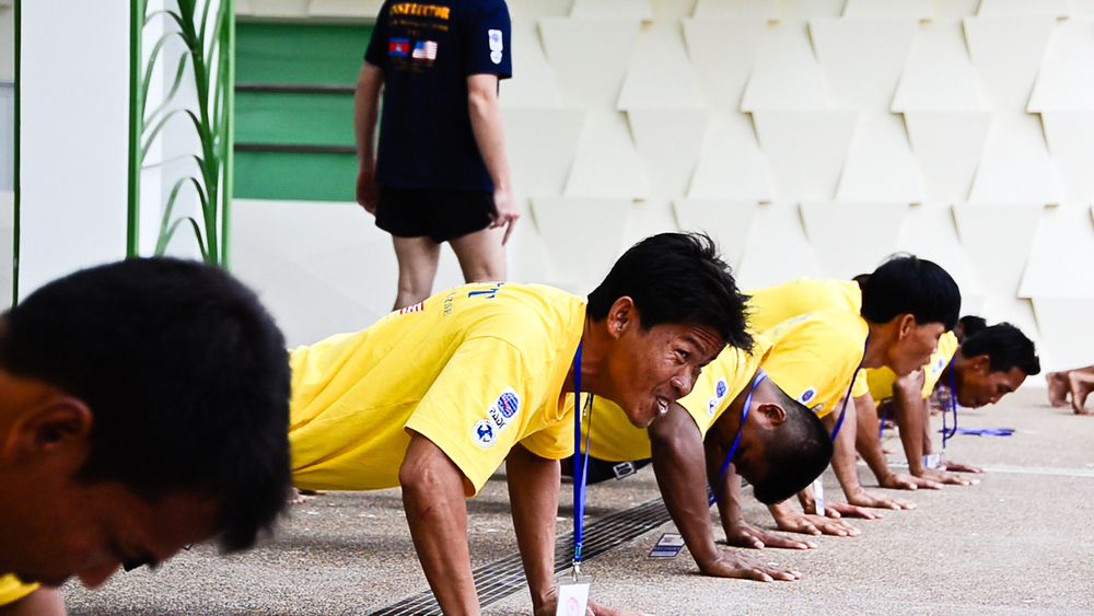  De-miners with the Cambodian Mine Action Centre (CMAC) do push-ups during land training for the country's first underwater UXO removal team. 