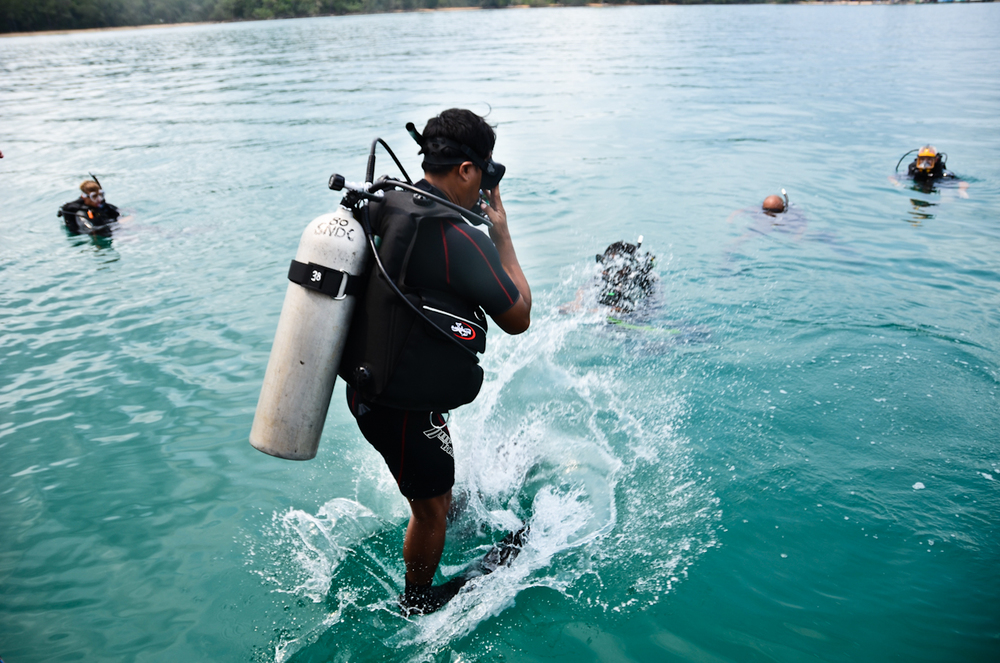  A recruit jumps into the water. Potential members of Cambodia's first underwater UXO salvage team will undergo months of training. 