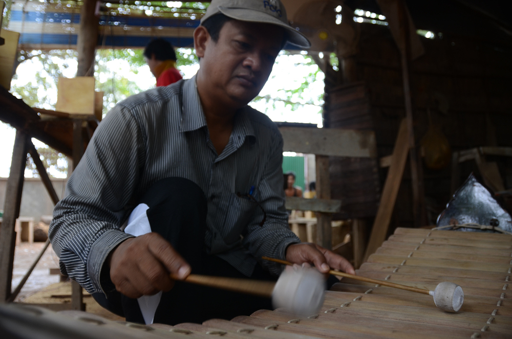  Keo Sonan Kavei plays the roneat, a type of Cambodian xylophone, at his instrument workshop near Phnom Penh. 